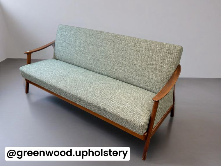 Mid-century open-arm settee, re-covered in a soft green wool.
