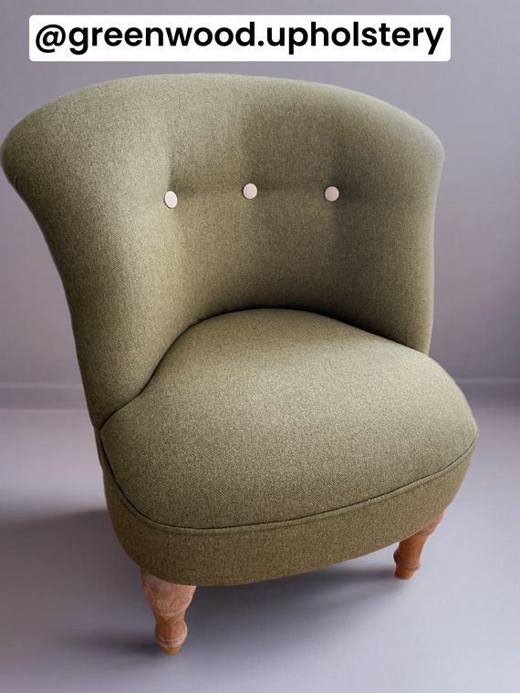 Bedroom tub chair in olive wool with contrast buttons.