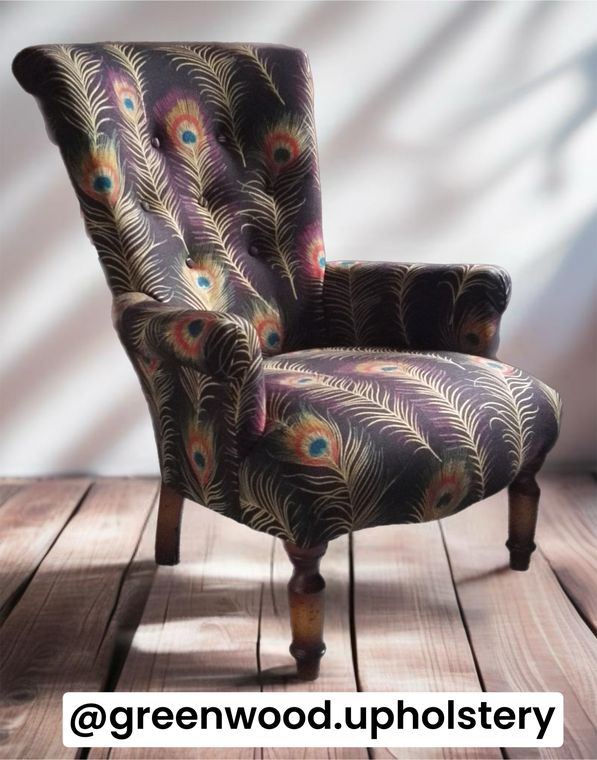 Small Victorian chair in a peacock-feather print, buttoned back.