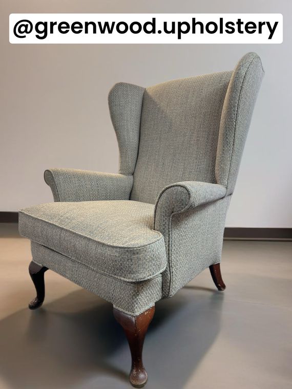 Queen Anne-style wing chair in a blue basket weave.