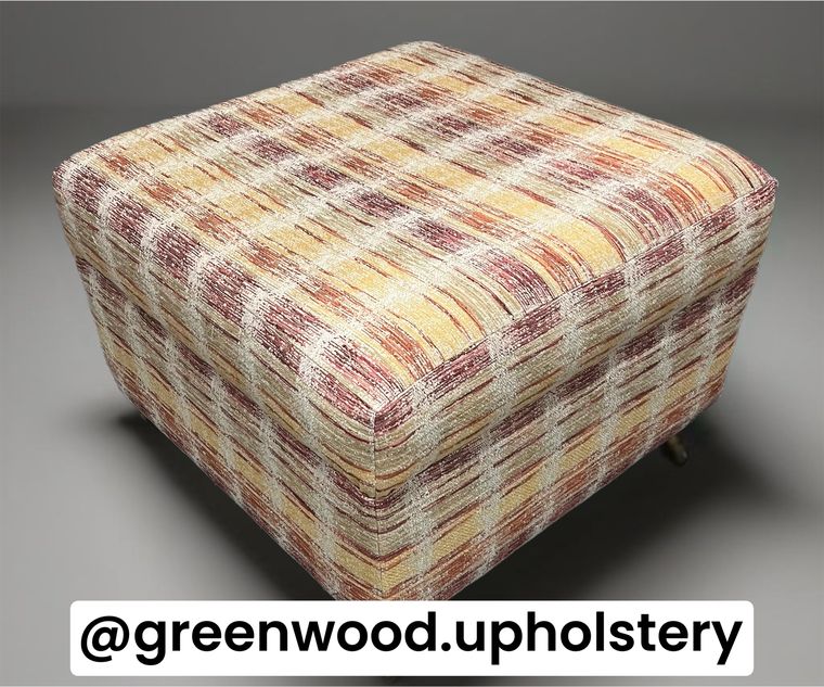 Deep ottoman footstool in a warm plaid chenille.