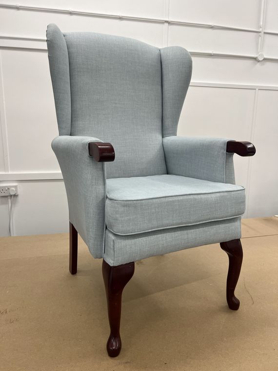 Wing-back fireside chair in duck-egg blue.