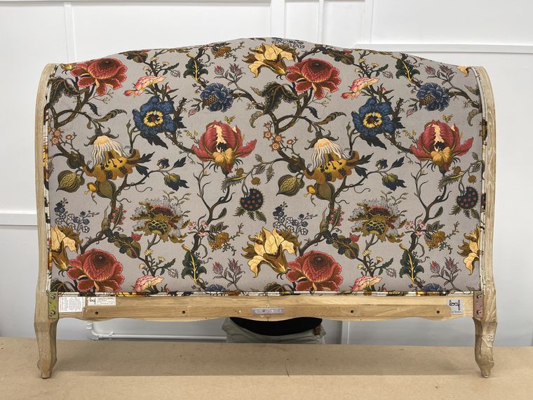 Upholstered headboard in a bold botanical print.