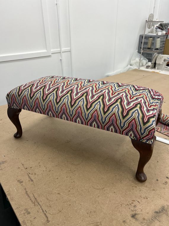 Bench footstool in a flame-stitch weave.