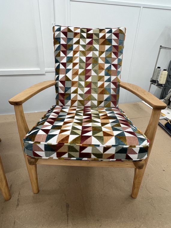 Mid-century open-arm chair in a geometric weave.