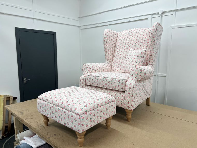 Wing-back chair and footstool in a floral sprig print.