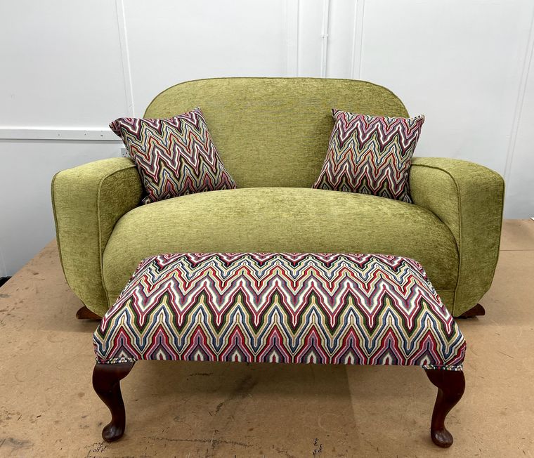 Snuggler armchair in green chenille with a flame-stitch footstool.