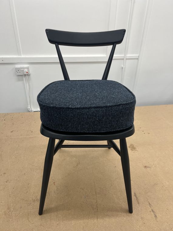 Painted stick-back chair with a charcoal wool seat.