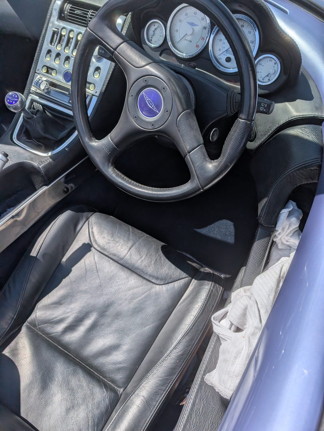 The driver's footwell and tunnel, navy running up to the console and switch panel.